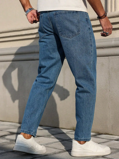 Men's jeans are made of classic blue denim fabric with a loose fit, making them an indispensable versatile item in the wardrobe.